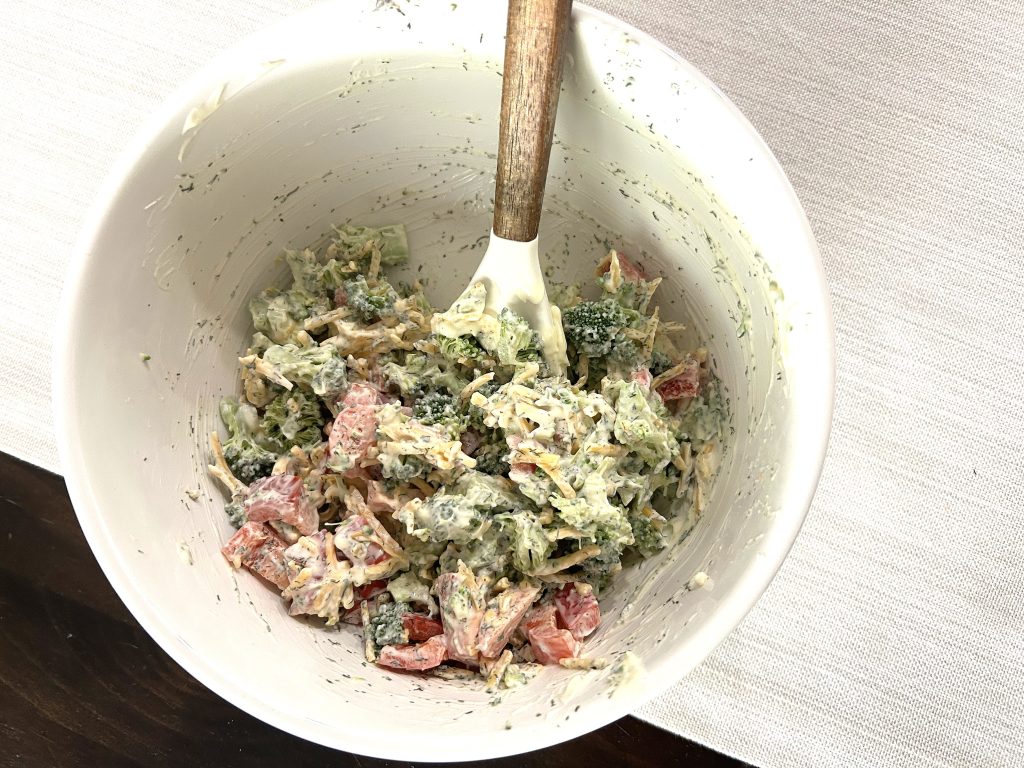 A white mixing bowl of mixed ingredients ready to be put into crescent rolls