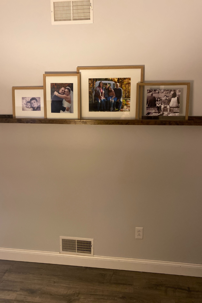 A finished picture ledge with a display of family photos