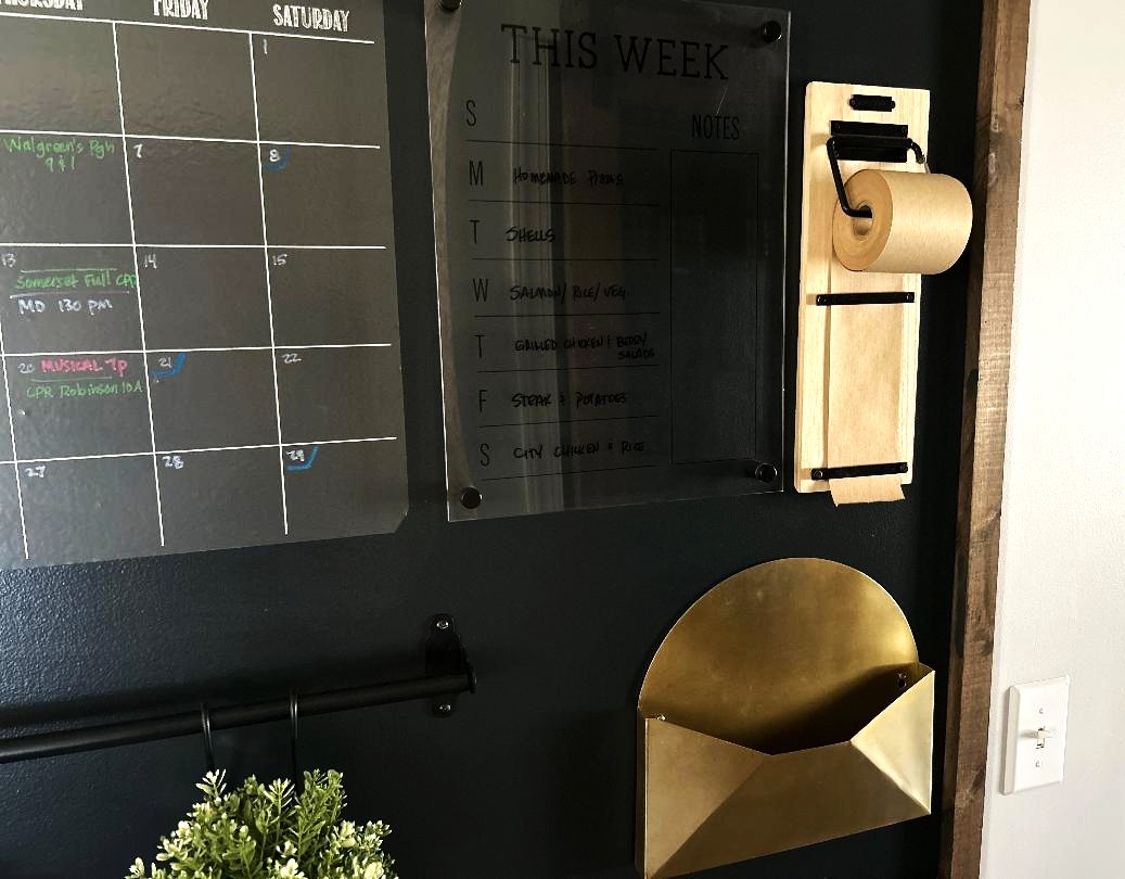 A close up pic of a clear hanging week menu board for a wall command center